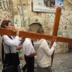 Via Dolorosa visitors carry cross