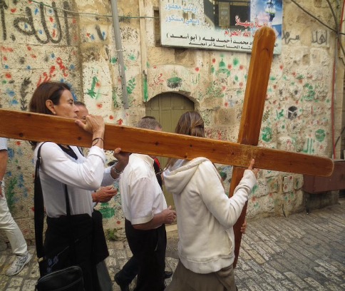 Via Dolorosa visitors carry cross